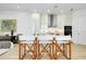 Bright kitchen with a center island, modern white cabinets, stainless steel appliances and director's chair seating at 33 S Palm Ave # 1602, Sarasota, FL 34236