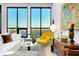 Sun-filled living room with floor-to-ceiling windows offering stunning skyline views and modern decor at 33 S Palm Ave # 1602, Sarasota, FL 34236