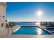 Stunning rooftop pool with chaise lounges and panoramic water views on a bright day at 33 S Palm Ave # 1602, Sarasota, FL 34236