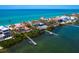Coastal property aerial view showcasing multiple waterfront homes, docks, and turquoise ocean views at 3300 Casey Key Rd, Nokomis, FL 34275