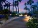 Landscaped backyard with a boardwalk leading to waterfront view and pool at 3300 Casey Key Rd, Nokomis, FL 34275