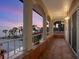 Mediterranean balcony with tiled floors and colorful flowers overlooking the water at 3300 Casey Key Rd, Nokomis, FL 34275