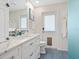 Bright bathroom with marble countertop vanity, blue backsplash, and door to the outdoors at 3300 Casey Key Rd, Nokomis, FL 34275