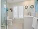 Bright bathroom featuring a toilet, walk-in shower, and white vanity with sink at 3300 Casey Key Rd, Nokomis, FL 34275