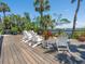 A backyard deck with white outdoor seating and a waterfront view at 3300 Casey Key Rd, Nokomis, FL 34275
