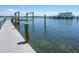 A dock on the water shows the house and a boatlift at 3300 Casey Key Rd, Nokomis, FL 34275