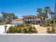 Stunning two-story home with a tile roof, three-car garage, lush landscaping, and a circular driveway at 3300 Casey Key Rd, Nokomis, FL 34275