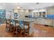 Spacious kitchen features terracotta floors, a large island, and custom cabinets at 3300 Casey Key Rd, Nokomis, FL 34275