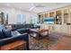 Spacious living room features a large leather sectional and custom built-ins at 3300 Casey Key Rd, Nokomis, FL 34275