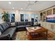 Comfortable living room featuring a plush leather sectional, built-in shelving, and ocean views at 3300 Casey Key Rd, Nokomis, FL 34275