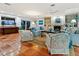 Spacious living room featuring tile floors, blue furniture, built-in shelving, and ocean views at 3300 Casey Key Rd, Nokomis, FL 34275