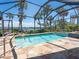 A screened pool area provides a serene view of tropical landscaping and the bay at 3300 Casey Key Rd, Nokomis, FL 34275