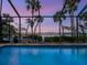 Screened pool area with mature landscaping and calming water view at 3300 Casey Key Rd, Nokomis, FL 34275