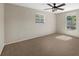 Bedroom featuring neutral carpeting, a ceiling fan, and ample natural light at 3301 62Nd Street W Cir, Bradenton, FL 34209