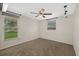 Another neutral bedroom features two windows, a ceiling fan, and neutral carpet at 3301 62Nd Street W Cir, Bradenton, FL 34209