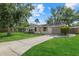 Single-story home with attached garage and well-maintained lawn, front view at 3301 62Nd Street W Cir, Bradenton, FL 34209