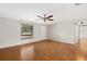Well-lit living room showcasing hardwood floors, a ceiling fan, and a bright window at 3301 62Nd Street W Cir, Bradenton, FL 34209