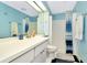 Bright blue bathroom with a shower, sink, and black and white tiled floor at 36750 Us 19 N # 03102, Palm Harbor, FL 34684