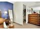 Bedroom features a blue accent wall, wardrobe, mirrored dresser and closet for ample storage at 36750 Us 19 N # 03102, Palm Harbor, FL 34684