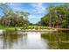 Picturesque golf course showcasing a lake with an island in the middle, displaying the word 'DUPREE' in shrubbery at 36750 Us 19 N # 03102, Palm Harbor, FL 34684