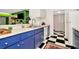 Bright kitchen with white appliances, blue cabinets, and black and white checkered floor at 36750 Us 19 N # 03102, Palm Harbor, FL 34684