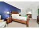 Spacious bedroom with king bed and dark blue accent wall at 36750 Us 19 N # 03102, Palm Harbor, FL 34684