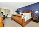 Bedroom showcasing a king bed, desk, and a dark blue accent wall at 36750 Us 19 N # 03102, Palm Harbor, FL 34684