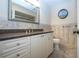 Bathroom featuring neutral paint, granite counters, undermount sink and framed mirror at 3843 El Poinier W Ct # 8720, Sarasota, FL 34232