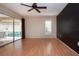 A well-lit bedroom offers a sliding glass door to the lanai and a modern ceiling fan at 3843 El Poinier W Ct # 8720, Sarasota, FL 34232