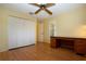 Bedroom with hardwood floors, ceiling fan, closet and office desk at 3843 El Poinier W Ct # 8720, Sarasota, FL 34232