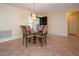 Bright dining area featuring tile flooring, chandelier, and a view to the front door at 3843 El Poinier W Ct # 8720, Sarasota, FL 34232