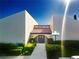 Striking front entrance showcasing unique architecture, professional landscaping, and a welcoming walkway at 3843 El Poinier W Ct # 8720, Sarasota, FL 34232