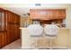 Kitchen bar with barstool seating and wood cabinets provides an open, inviting space at 3843 El Poinier W Ct # 8720, Sarasota, FL 34232
