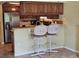 The kitchen has stainless steel appliances, bar seating, and beautiful tile flooring at 3843 El Poinier W Ct # 8720, Sarasota, FL 34232