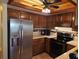 Modern kitchen showcases stainless steel appliances, oak cabinetry, and attractive backsplash at 3843 El Poinier W Ct # 8720, Sarasota, FL 34232