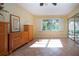 Bright living room features wood cabinetry, window with shutters and tile floors at 3843 El Poinier W Ct # 8720, Sarasota, FL 34232