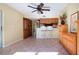 Open-concept living room with tile flooring, wood cabinetry, and easy access to kitchen at 3843 El Poinier W Ct # 8720, Sarasota, FL 34232