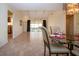 Open-concept living and dining area with tile flooring and a view to the lanai at 3843 El Poinier W Ct # 8720, Sarasota, FL 34232