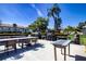 Outdoor patio area with picnic tables and BBQ grills, perfect for entertaining at 3843 El Poinier W Ct # 8720, Sarasota, FL 34232