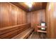 Relaxing sauna featuring wood paneling, built-in benches, and a heater for a luxurious spa experience at 3843 El Poinier W Ct # 8720, Sarasota, FL 34232