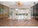 Bright sunroom features tile floors, white furniture, and sliding glass doors with exterior view at 3843 El Poinier W Ct # 8720, Sarasota, FL 34232