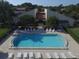 Overhead view of community pool and sunbathing area with lounge chairs at 3843 El Poinier W Ct # 8720, Sarasota, FL 34232