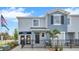 Charming two-story townhome with a black metal fence, blue accents, and professional landscaping at 4085 Gold Dust Ln, Sarasota, FL 34243