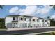 A row of newly constructed townhomes features light-colored exteriors, front-facing garages and tidy landscaping at 4085 Gold Dust Ln, Sarasota, FL 34243