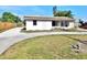 View of single-story home, with a large driveway and front lawn needing landscaping at 4221 26Th W St, Bradenton, FL 34205