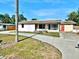 Exterior view of a single-story home featuring a spacious driveway and lawn with landscaping at 4221 26Th W St, Bradenton, FL 34205