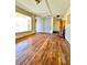 Spacious living room with hardwood floors, a large window, and an exit sign above a door at 4221 26Th W St, Bradenton, FL 34205