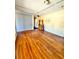 Spacious living room featuring hardwood floors, a large window, and an exit sign at 4221 26Th W St, Bradenton, FL 34205