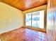 Cozy sunroom featuring wood ceiling, tile floors, and a bright window to street view at 4221 26Th W St, Bradenton, FL 34205