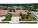 Inviting single-Gathering home featuring a spacious driveway, well-manicured lawn, and lush landscaping in quiet neighborhood at 4706 Josselin Pl, Parrish, FL 34219